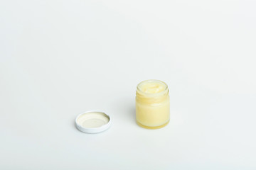 opened cosmetic jar with creme