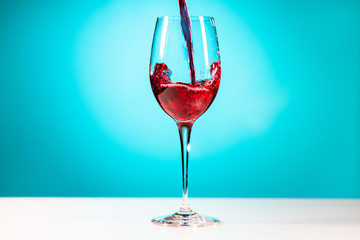 Glass of red wine on the blue background.