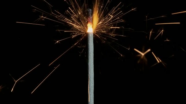 Closeup, Christian sparklers, Bengal lights on black background. Firework sparkler burning on dark background.