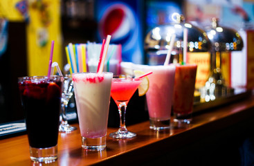 range of different fresh alcohol berry cocktails in a bar