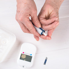 Sugar test for diabetics, close-up of the arm and a drop of blood