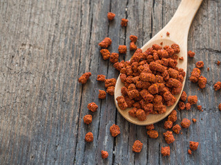 Asian spices. Dry adjika in spoon on wooden background. Closeup