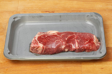 Rib eye steak in a carton