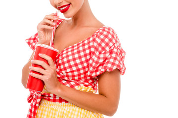 Partial view of pin up girl drinking from red disposal cup with straw isolated on white