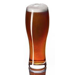 Classic draft pale ale beer in a weizen glass isolated on white background.