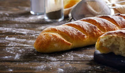 Fresh French loaf with a ruddy crust on a wooden table