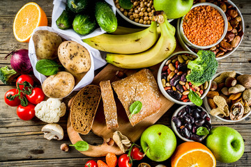 Healthy food. Selection of good carbohydrate sources, high fiber rich food. Low glycemic index diet. Fresh vegetables, fruits, cereals, legumes, nuts, greens.  copy space - obrazy, fototapety, plakaty