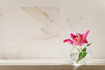 White Marble Shelf Table Top can used for display or montage your products. Pink Lily Flower in Glass Vase Luxury Bathroom interior Cleanliness Beauty Concept 
