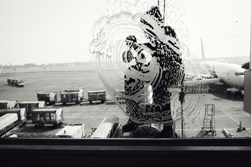 Worker is cleaning windows glass in the airport terminal., Silhouette of employee is rappelling for wipe cleaning exterior glass of building., Occupation and service concept.