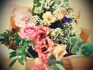 Flower bouquet detail. Vintage design arranging nosegay with pink roses, lisianthus, gypsophila and eucalyptus leaves