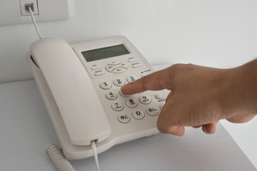 Man finger push home telephone button.