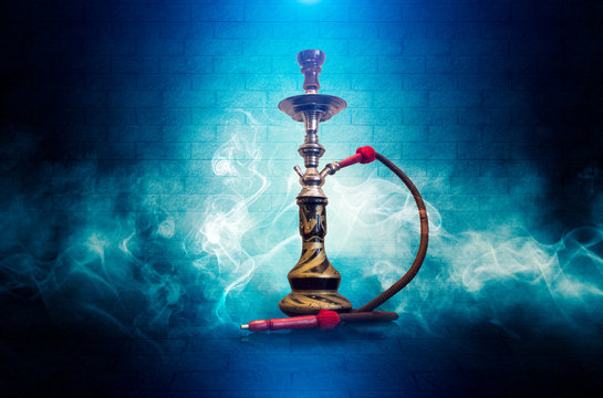 Smoke hookah dark, blue grunge background. Concrete covering, tile. Neon light, smoke, smog