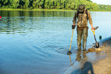 Metal detectors are looking for a treasure on the beach