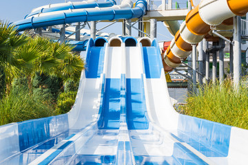 Adult water slides with pipes in water park.
