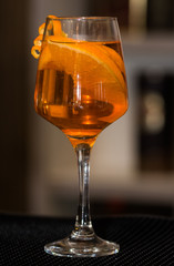 Refreshing cocktail with orange peel decoration