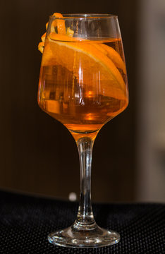Refreshing cocktail with orange peel decoration