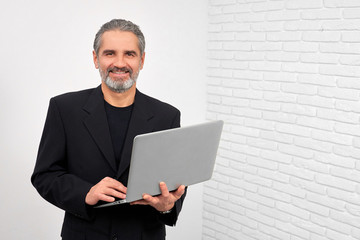 Man smiling, posing with notebook in studio.