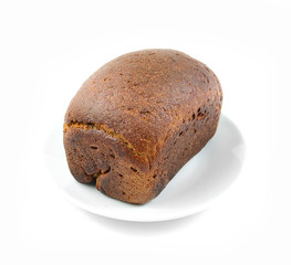 a loaf of rye bread on a white plate on white background