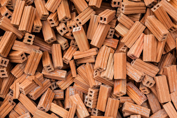 group of bricks square construction materials. bricks texture and abstract in vignette for background or copy space for text fill. Stack of disorganized brown bricks.