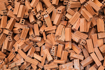 group of bricks square construction materials. bricks texture and abstract in vignette for background or copy space for text fill. Stack of disorganized brown bricks.