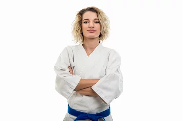 Tuinposter Portrait of female wearing martial arts uniform standing with arms crossed © Catalin Pop