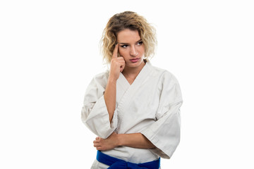 Portrait of female wearing martial arts uniform making thinking gesture