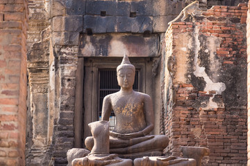 Ancient Buddha in Phra Prang Sam Yod a former Hindu shrine built in the 13th century in the classic Bayon style of Khmer architecture.Thailand.