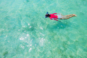 Girl snorkeling in the water of sea