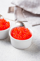 Two bowls with red salmon caviar