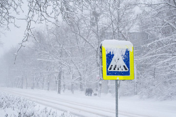 snow covered road sign