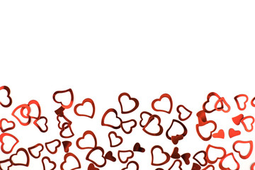 Little red confetti hearts on white background.