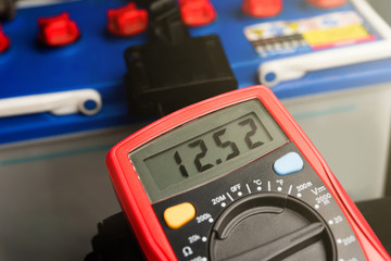 Checking voltage battery of ca with volt meter 12 v. dc