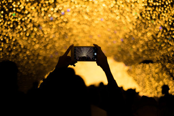 Nagoya, Japan-March 15, 2018, Taking a photo with smartphone at Nabana No Sato Spring Illumination, Nagashima spa land, Nagoya, Japan.