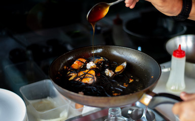 cooking Black Spaghetti in a pan