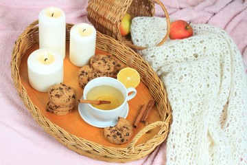 Obraz na płótnie Canvas Hygge autumn or winter time for tea. Flat lay with tea, cookies, candles, lemon and scarf