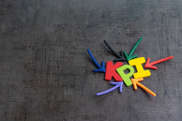 KPI, Key Performance Indicator business target or score to measure success in marketing campaign concept by multiple arrow pointing to colorful alphabet KPI at the center