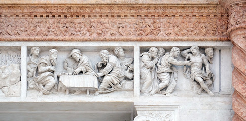 Supper at Emmaus left and Doubting Thomas right by Zaccaria da Volterra, door of San Petronio Basilica in Bologna, Italy