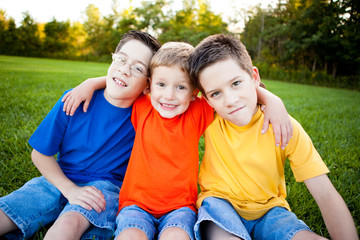 Boys Sitting Together in Grass Outside