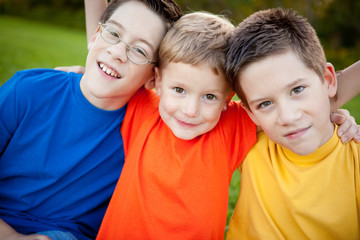 Boys Sitting Together in Grass Outside