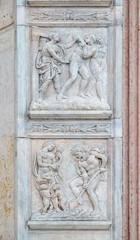 Fototapeta na wymiar Expulsion from Paradise up, the work of Adam and Eve down, panel by Jacopo della Quercia on the central door of San Petronio Basilica in Bologna, Italy