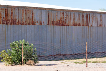 Side of a partially rusted metal building