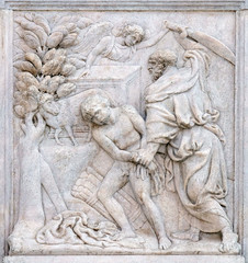 Fototapeta na wymiar Abraham Sacrificing Isaac, relief on portal of Saint Petronius Basilica in Bologna, Italy