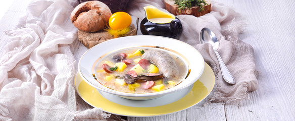 a polish easter soup with homemade white sausage and mushrooms