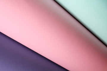 Abstract asymmetric volumetric paper background in pastel colors. Geometric paper background in soft pastel pink, blue and purple colors.