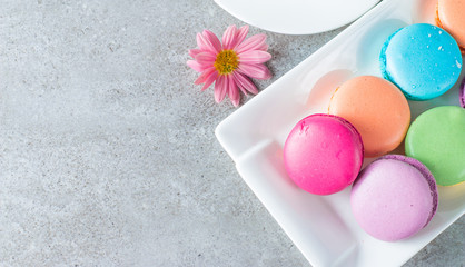 Photo of cake macarons, gift box, tea, coffee, cappuccino and flowers. Sweet romantic food macaroon concept. Morning breakfast and presents. Valentine's day concept.