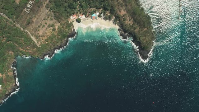 Drone Aerial Flight: Ocean Beach Waves On White Sand. Crystal Water Landscape In Tropical Bali Island, Indonesia. Travel Vacation Recreation. From Above, Zoom Out, Fast Speed Motion Hyperlapse. 4K