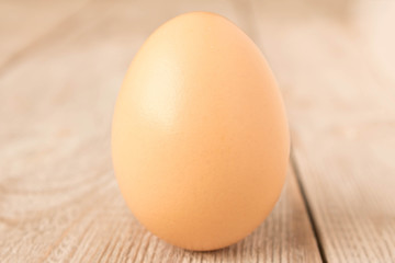 Chicken egg on a wooden table. Close up.