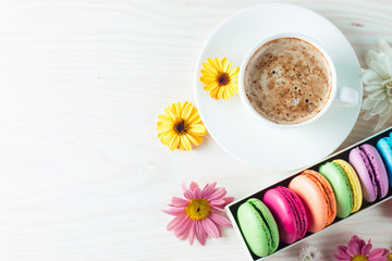 Photo of cake macarons, gift box, tea, coffee, cappuccino and flowers. Sweet romantic food macaroon concept. Morning breakfast and presents. Valentine's day concept.