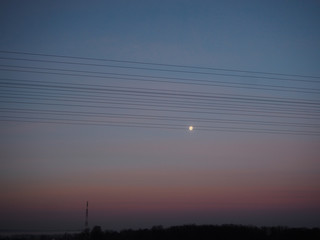 The moon in the sky is similar to a note on a sheet of music