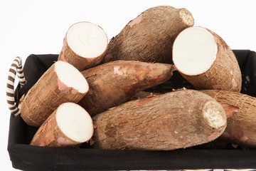 Raw yucca on white background-Manihot esculenta. (Cassava raw tuber)